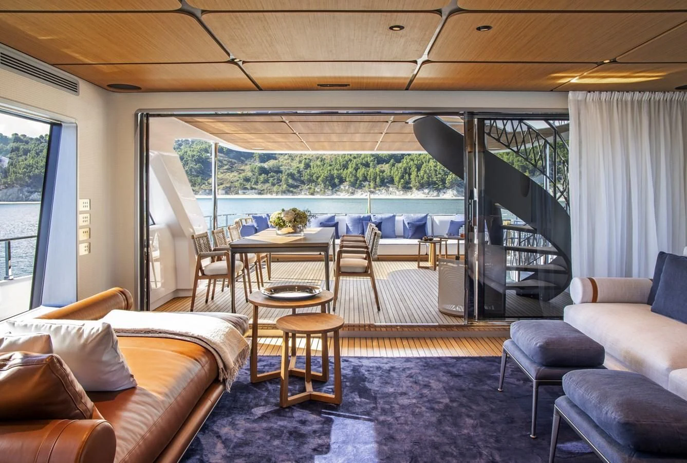 a living room with a large patio aboard UPSTREAM Yacht for Sale