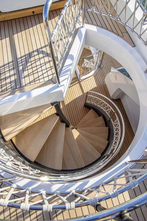 a spiral staircase with a spiral staircase aboard UPSTREAM Yacht for Sale
