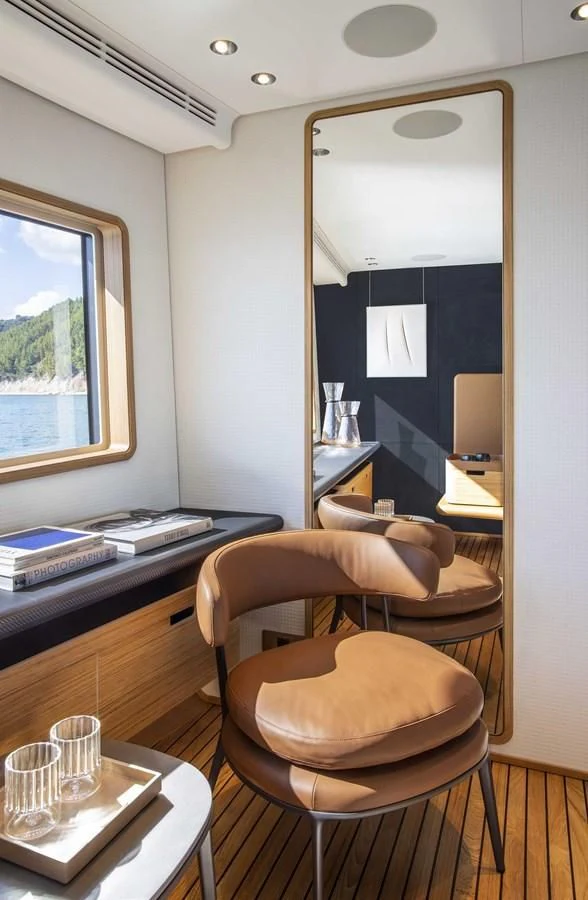 a room with a table chairs and a mirror aboard UPSTREAM Yacht for Sale