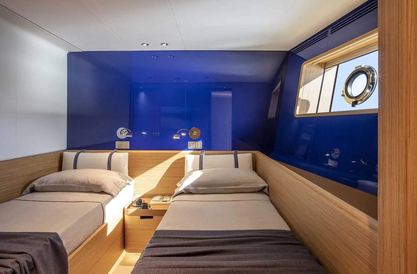 a room with beds and a mirror aboard UPSTREAM Yacht for Sale
