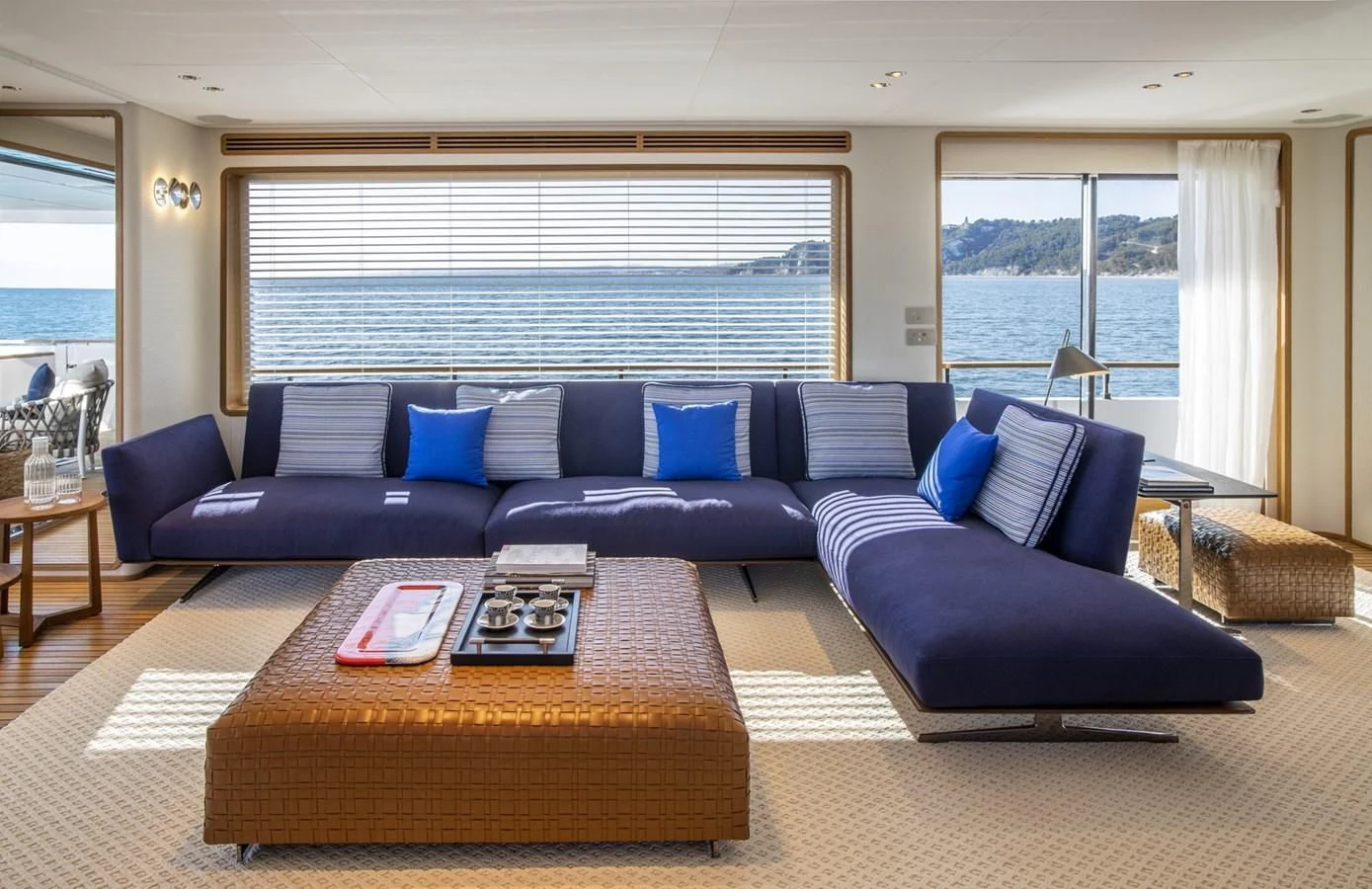 a living room with a couch and a coffee table aboard UPSTREAM Yacht for Sale