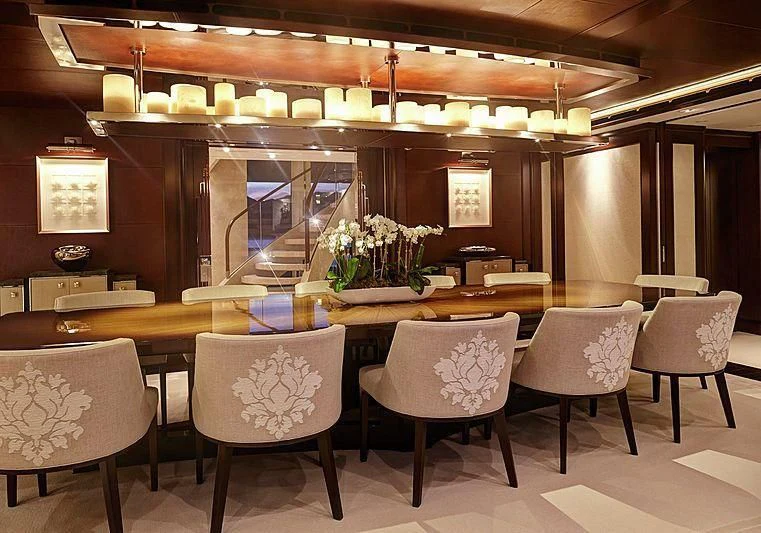 a room with a table chairs and a window aboard HAMPSHIRE Yacht for Sale