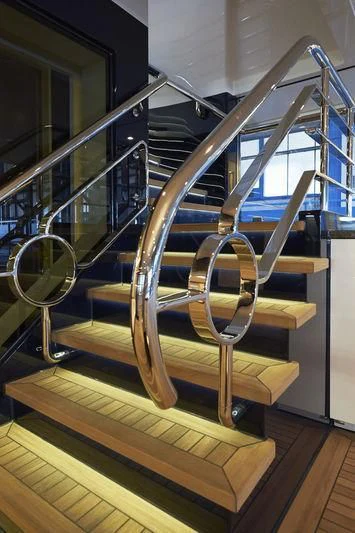 a wooden spiral staircase aboard HAMPSHIRE Yacht for Sale