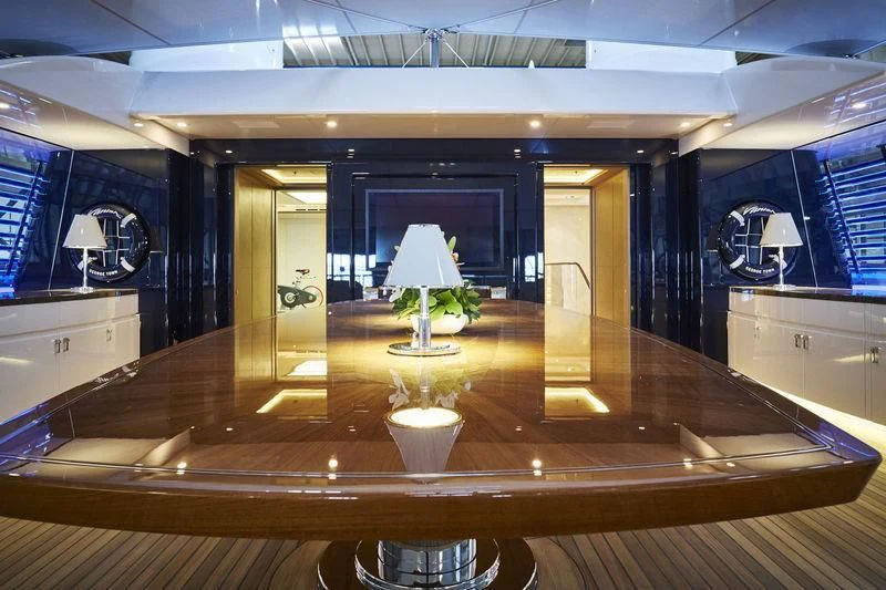 a room with a large mirror and a table with chairs aboard HAMPSHIRE Yacht for Sale