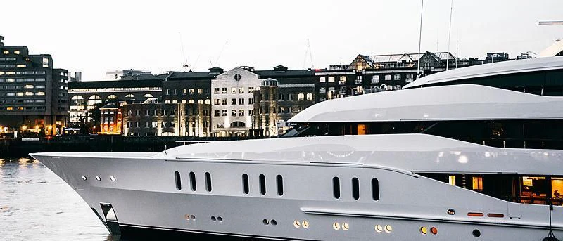 a white boat in a harbor aboard HAMPSHIRE Yacht for Sale