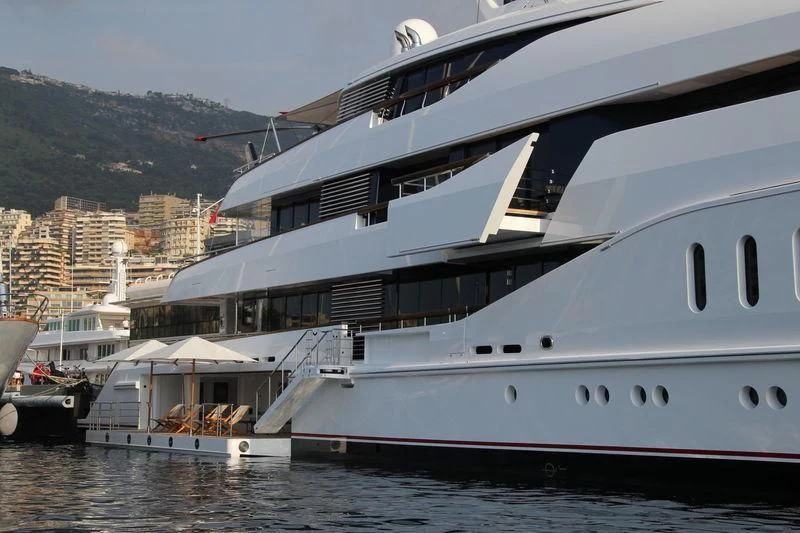 a large white boat in a harbor aboard HAMPSHIRE Yacht for Sale