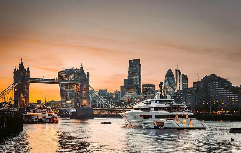 a boat in the water by a bridge and a city aboard HAMPSHIRE Yacht for Sale
