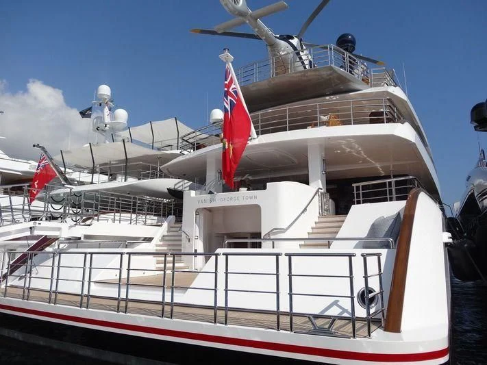 a large ship with a flag on the deck aboard HAMPSHIRE Yacht for Sale