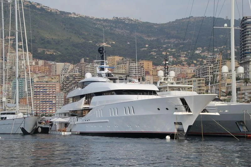 a large white boat in a harbor aboard HAMPSHIRE Yacht for Sale