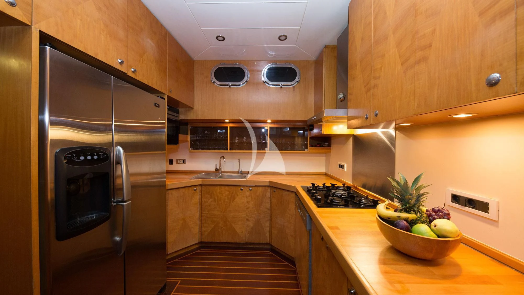 a kitchen with a stainless steel refrigerator aboard SERENITY 86 Yacht for Charter