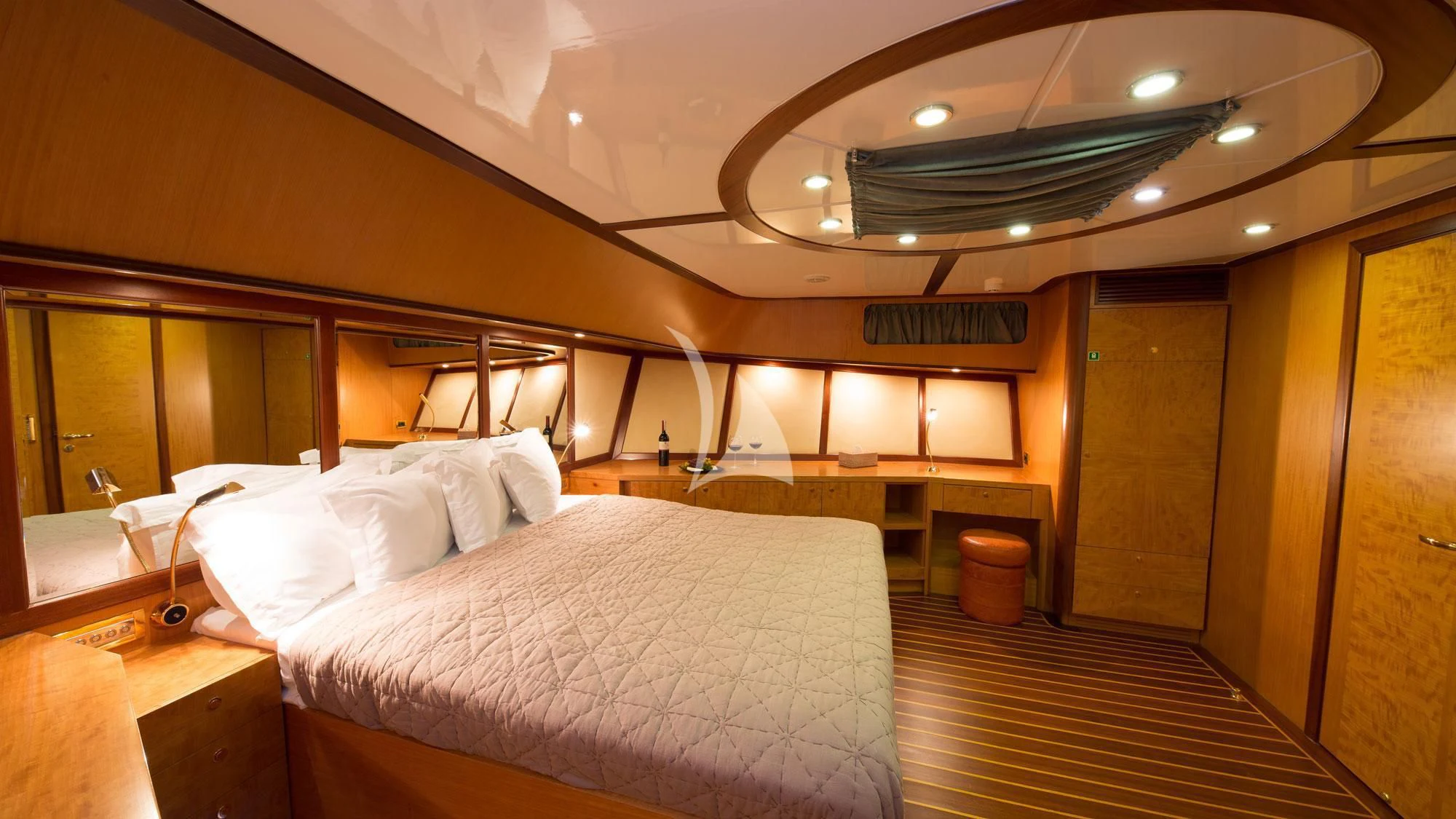 a room with a bed and a table aboard SERENITY 86 Yacht for Charter