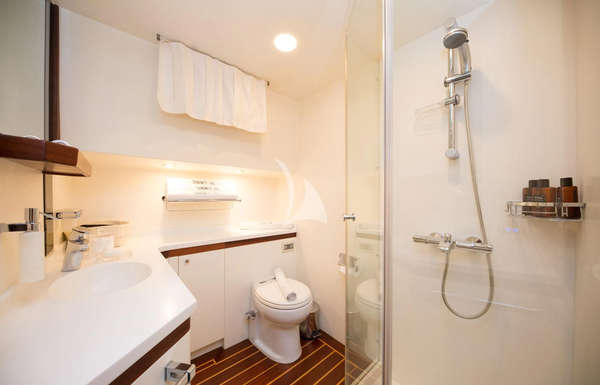 a bathroom with a sink and a toilet aboard SERENITY 86 Yacht for Charter