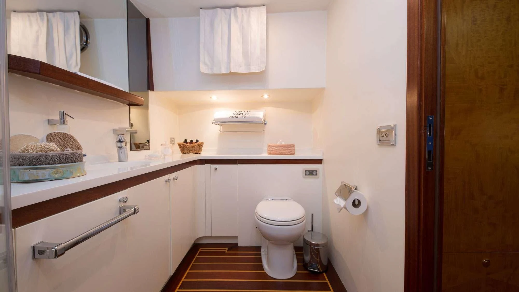 a bathroom with a toilet and a sink aboard SERENITY 86 Yacht for Charter