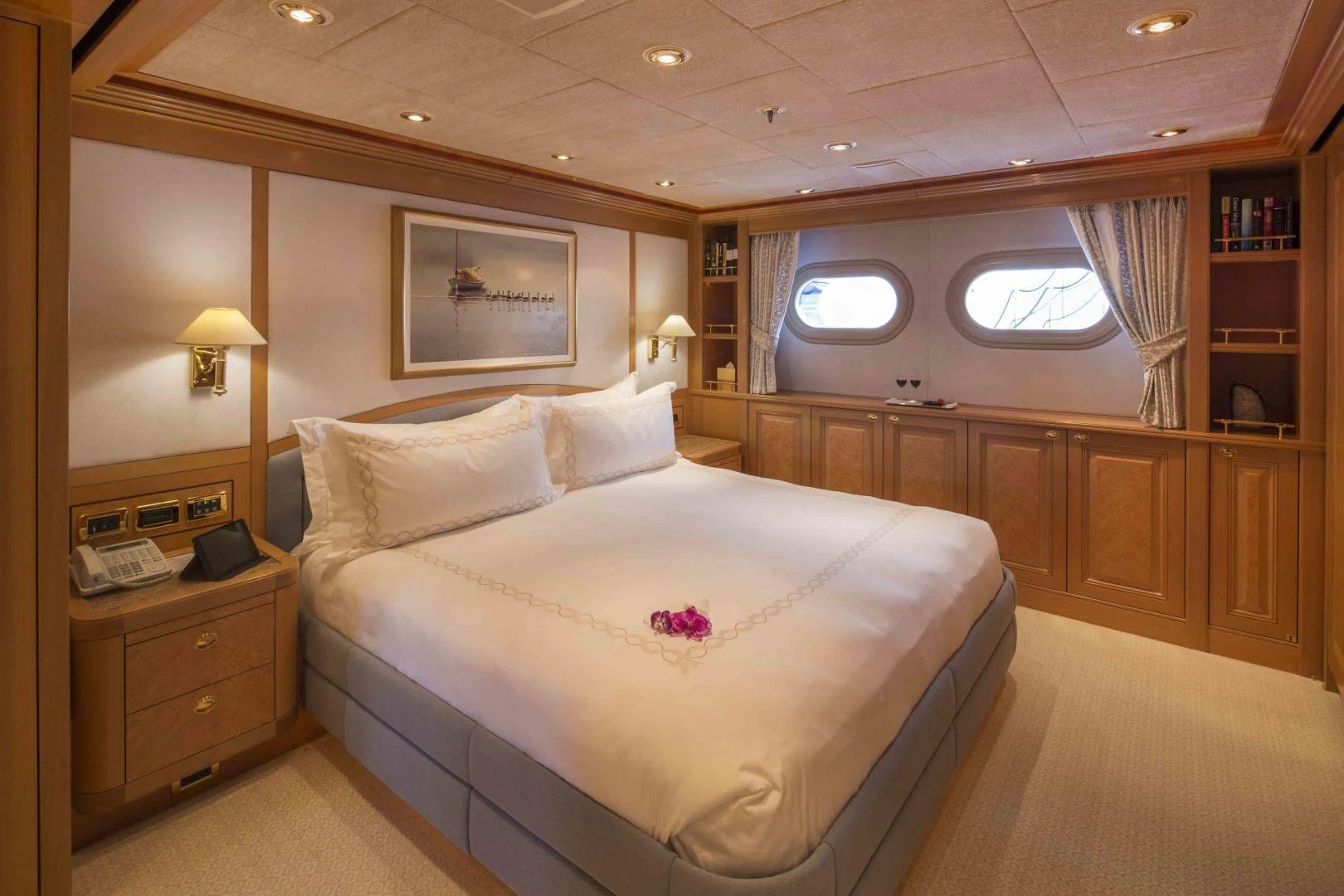 a room with a bed and a bookcase aboard LAUREL Yacht for Charter