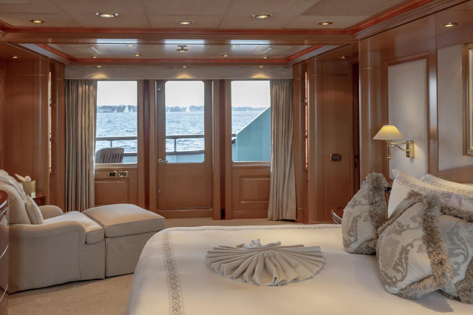 a hotel room with a bed and a large window aboard LAUREL Yacht for Charter