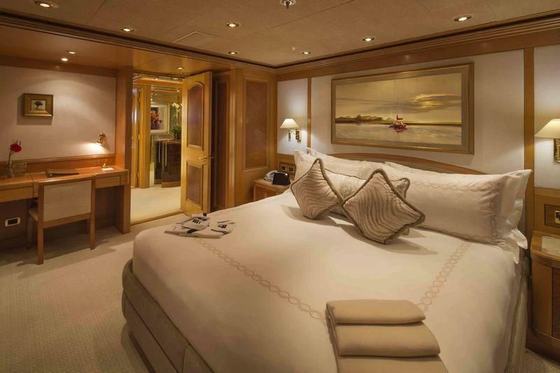 a hotel room with a bed and desk aboard LAUREL Yacht for Charter