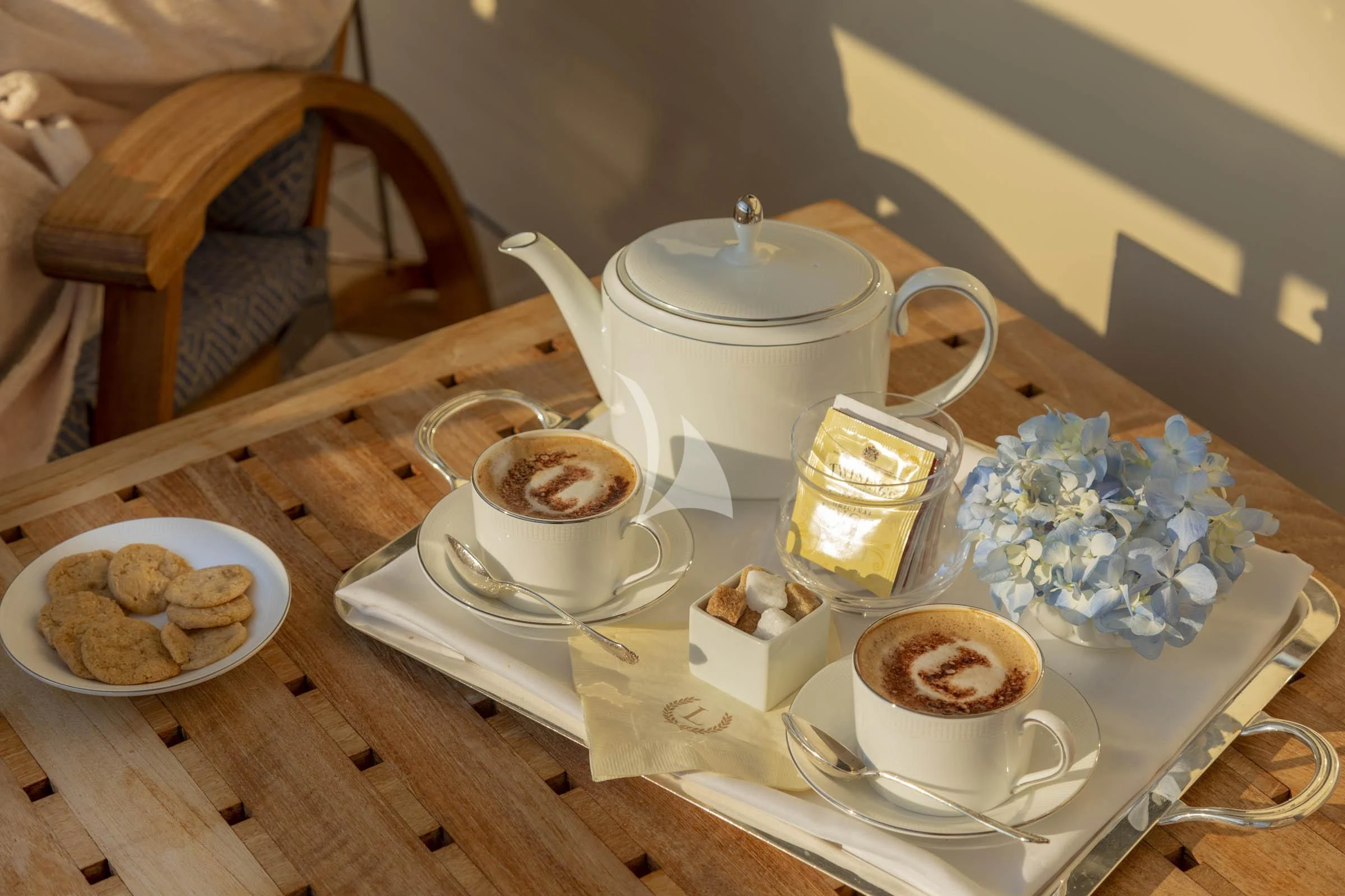 a table with a plate of food and cups on it aboard LAUREL Yacht for Charter