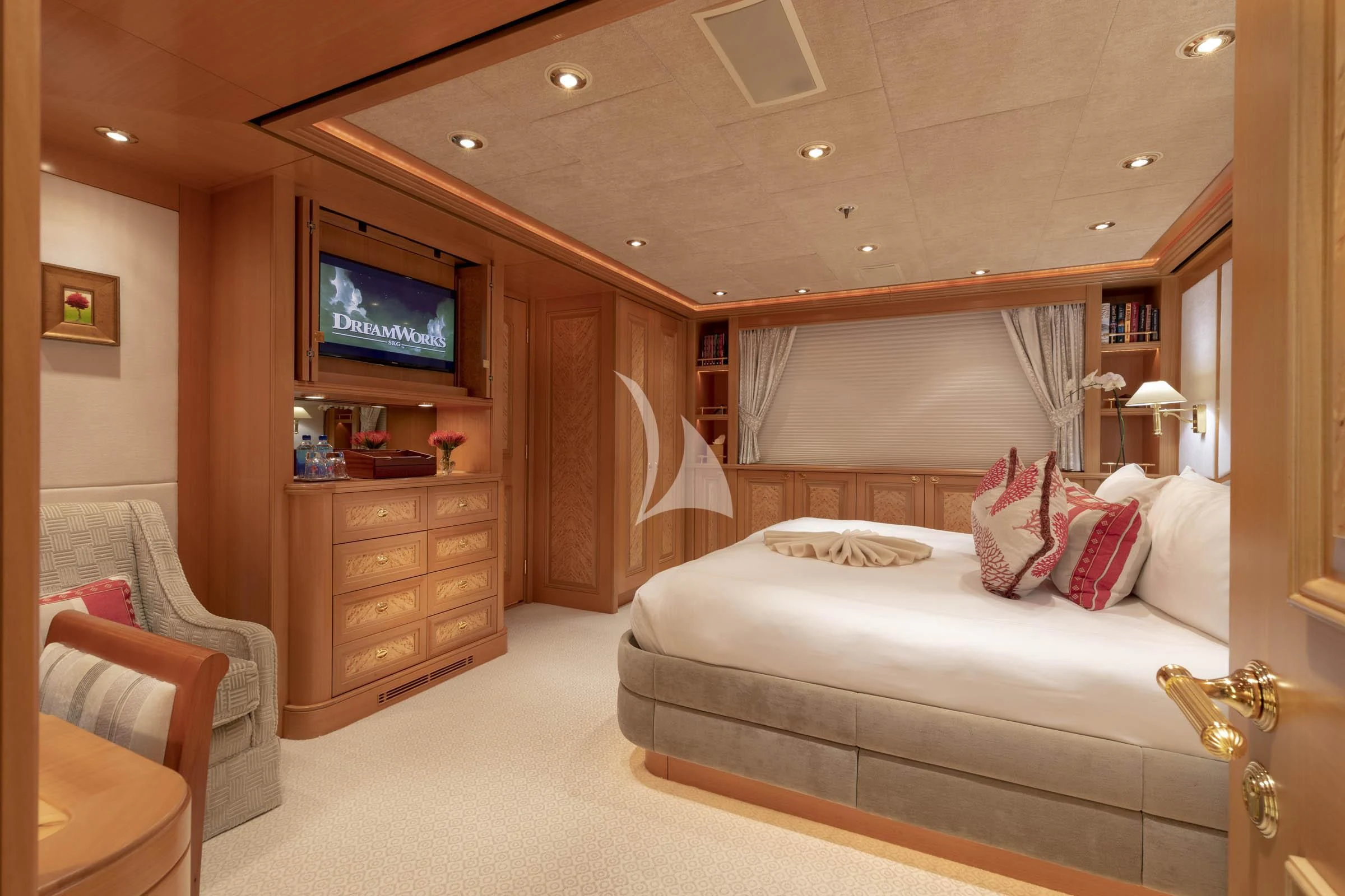 a bedroom with a bed and a tv aboard LAUREL Yacht for Charter