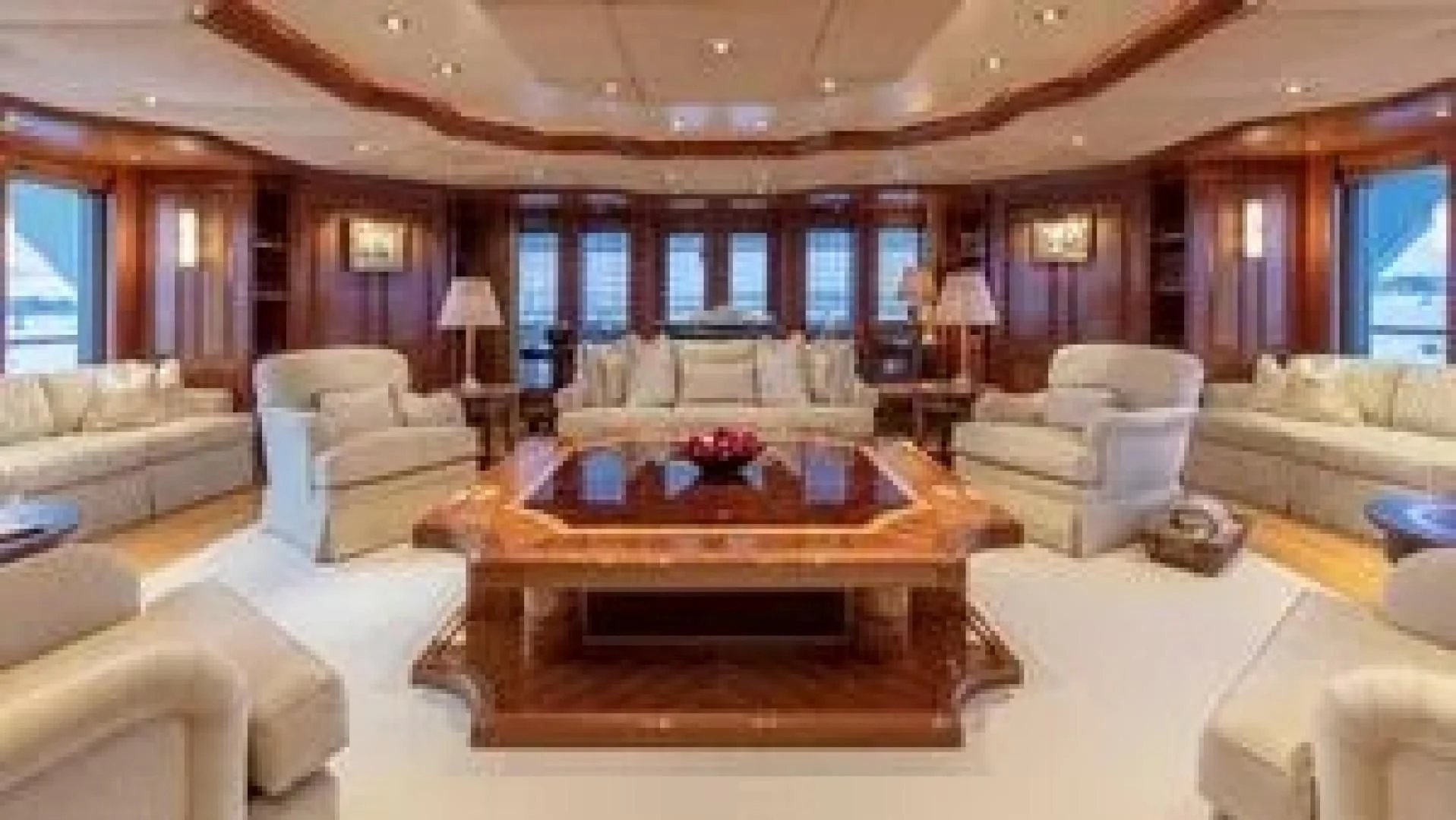 a living room with a large table aboard LAUREL Yacht for Charter