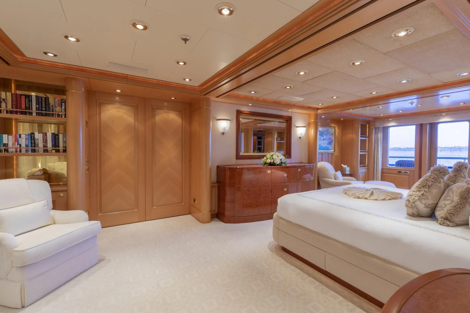 a bedroom with a large wood cabinet aboard LAUREL Yacht for Charter