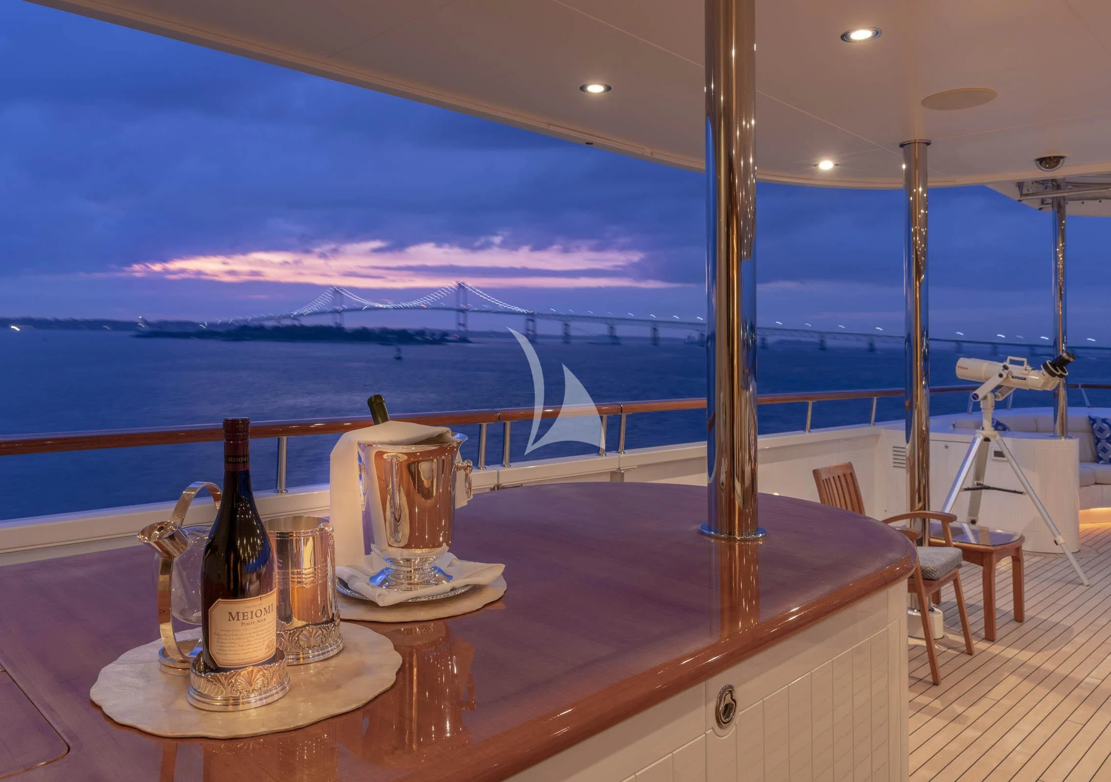 a table with glasses and bottles on it aboard LAUREL Yacht for Charter
