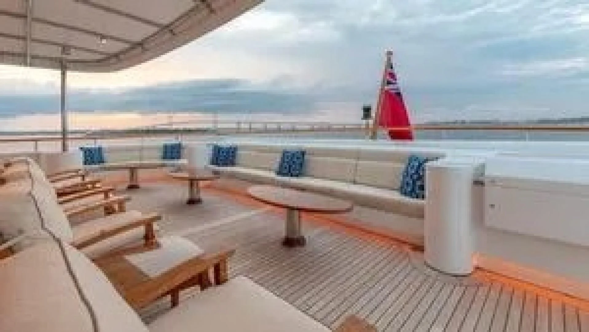 a deck with a view of the ocean and a large red tower aboard LAUREL Yacht for Charter