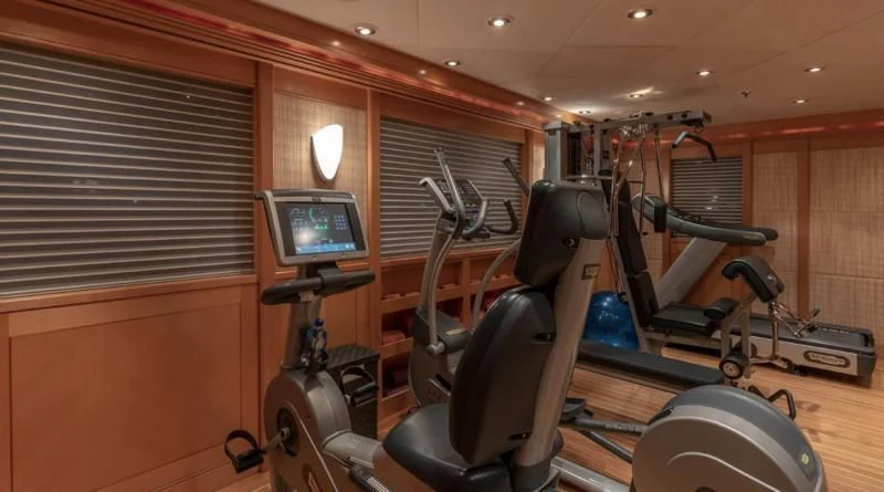 a room with a tv and exercise equipment aboard LAUREL Yacht for Charter