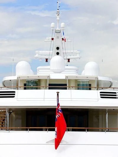 a flag on a pole in front of a large building aboard LAUREL Yacht for Charter