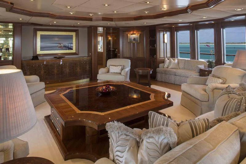 a living room with a table and couches aboard LAUREL Yacht for Charter
