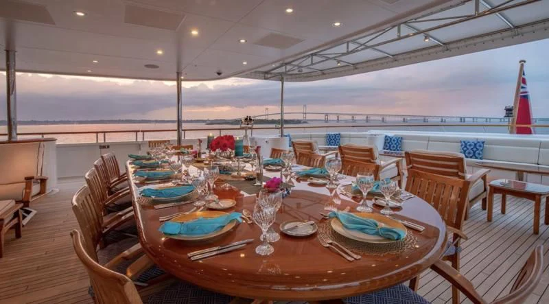 a table set with plates and glasses aboard LAUREL Yacht for Charter