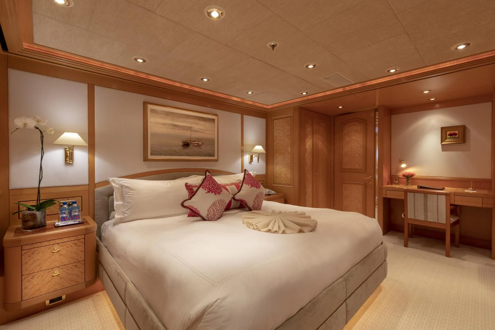 a bedroom with a bed and a desk aboard LAUREL Yacht for Charter