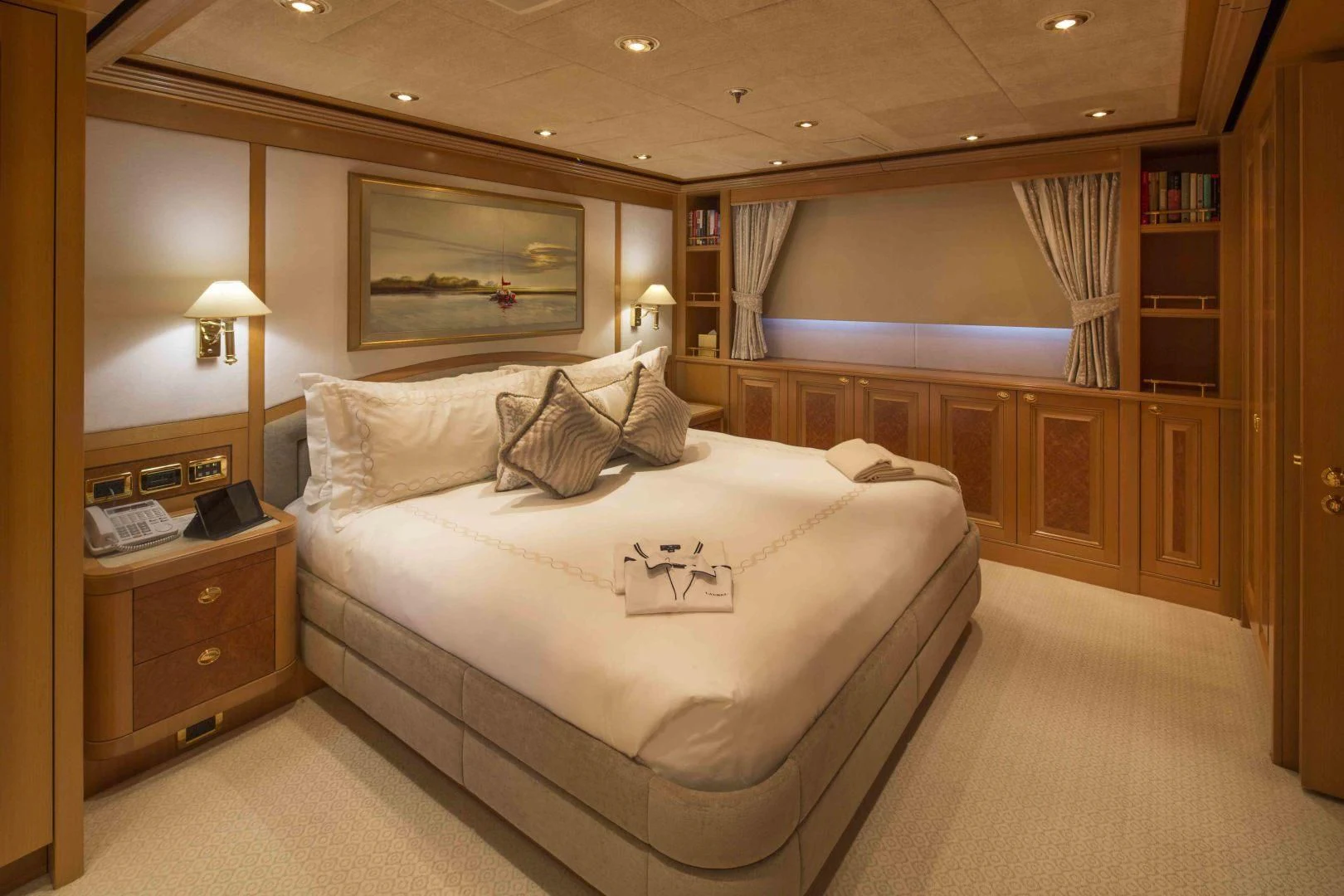 a bedroom with a bed and a desk aboard LAUREL Yacht for Charter