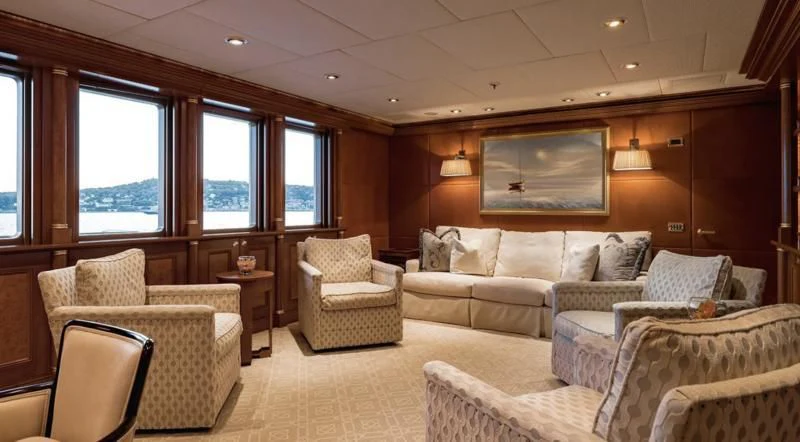 a living room with couches and a television aboard LAUREL Yacht for Charter