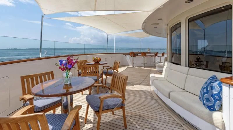 a boat with a table and chairs aboard LAUREL Yacht for Charter