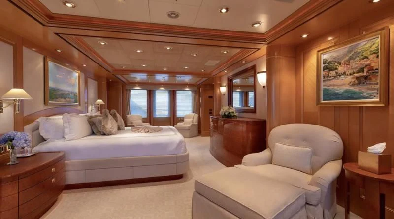 a large bedroom with a bed and a large window aboard LAUREL Yacht for Charter