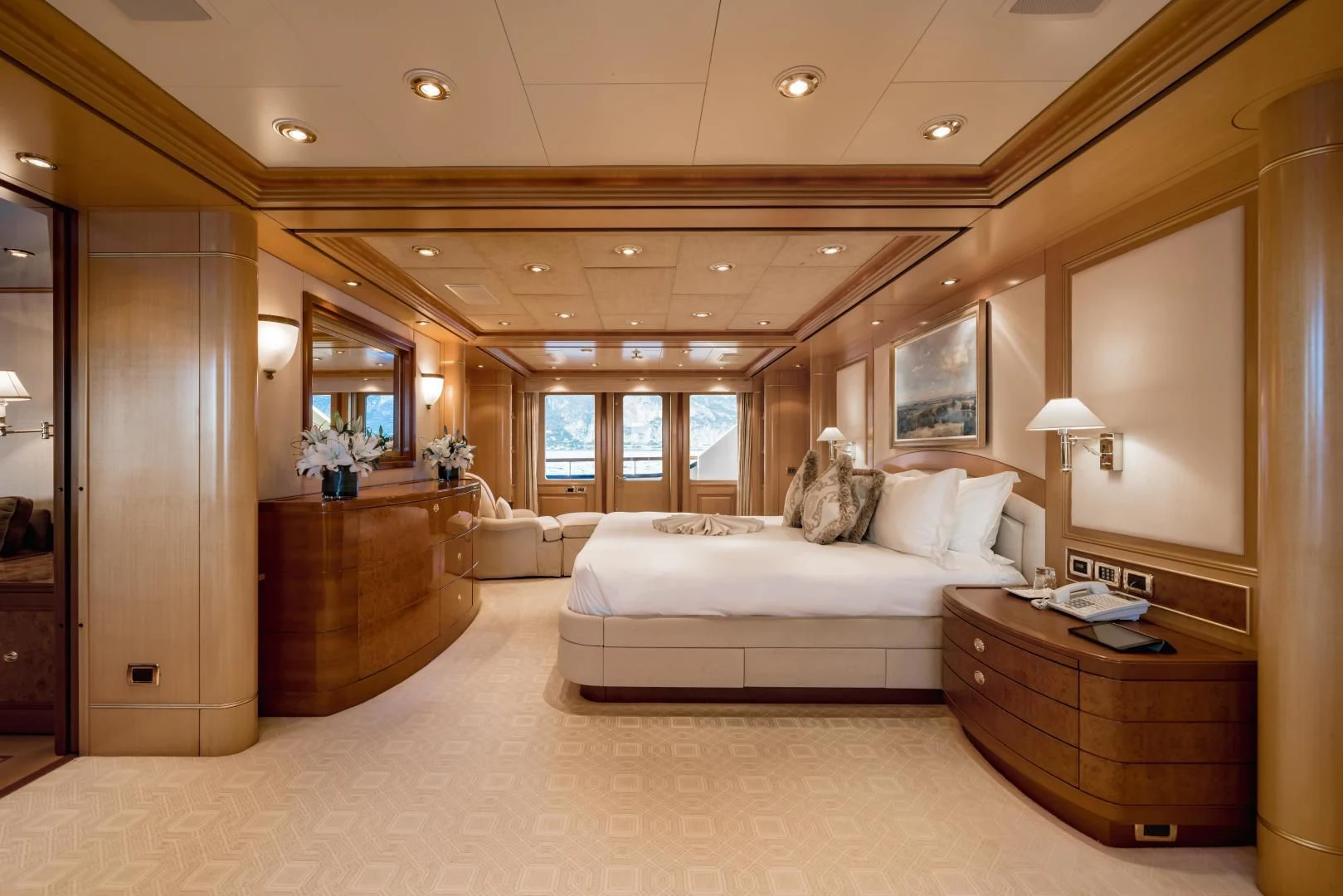 a large bedroom with a large mirror aboard LAUREL Yacht for Charter