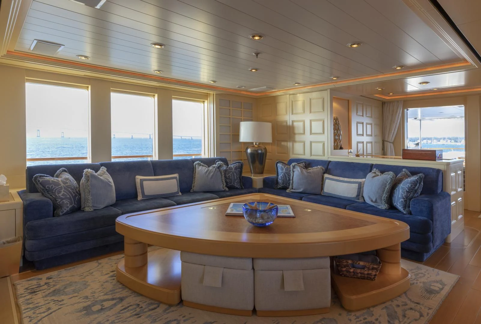 a living room with a large sectional sofa and a coffee table aboard LAUREL Yacht for Charter