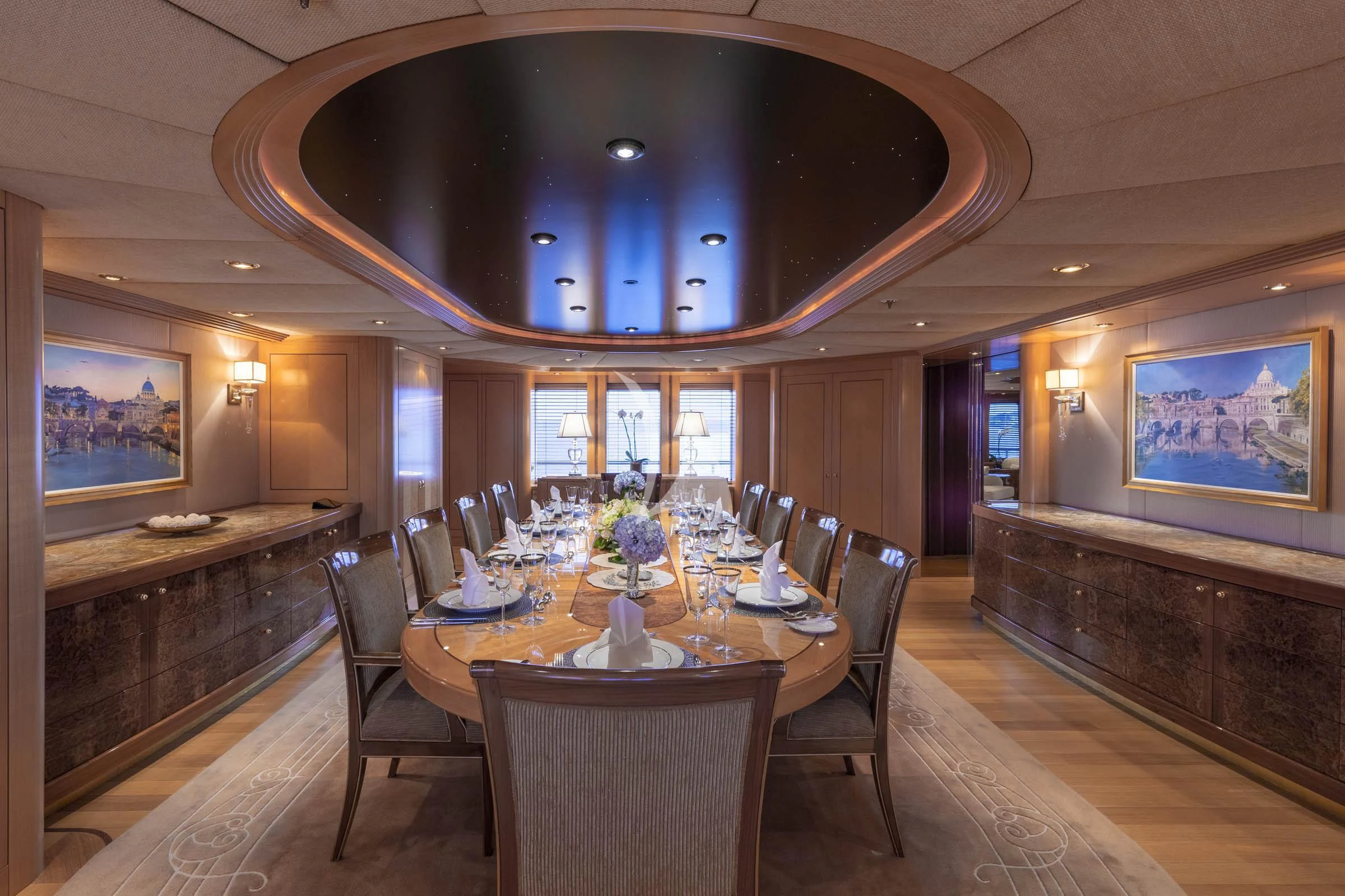 a large room with tables and chairs aboard LAUREL Yacht for Charter
