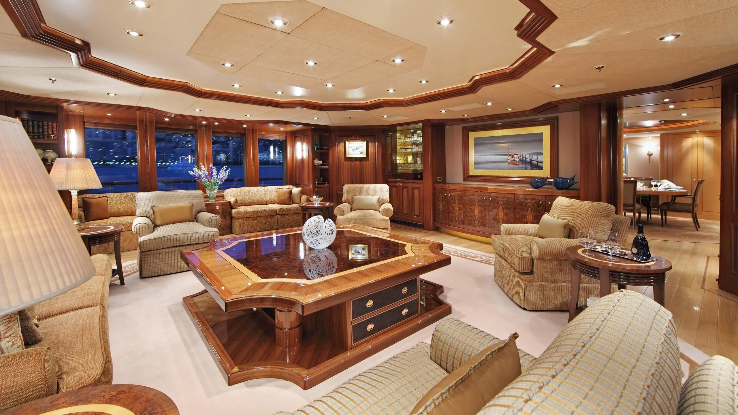 a living room with a table and couches aboard LAUREL Yacht for Charter