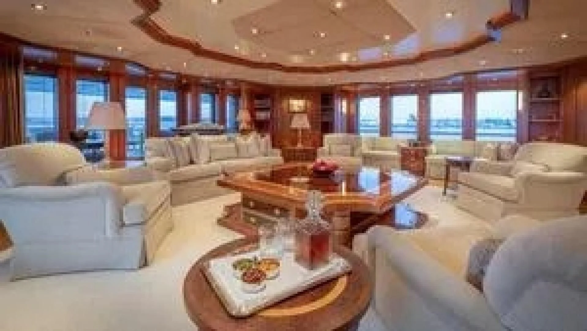 a large living room with a large table and chairs aboard LAUREL Yacht for Charter