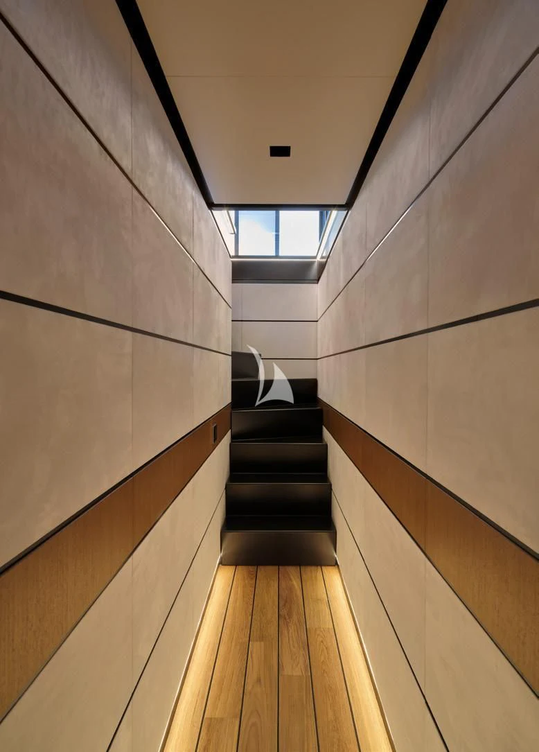 a room with a wood floor and a staircase aboard BAD MUTHA Yacht for Sale