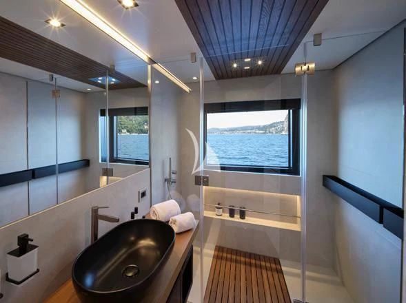 a bathroom with a sink and a large window aboard BAD MUTHA Yacht for Sale