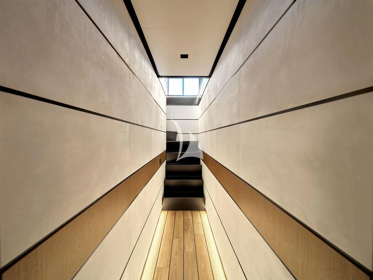 a hallway with a wood floor and a window aboard BAD MUTHA Yacht for Sale