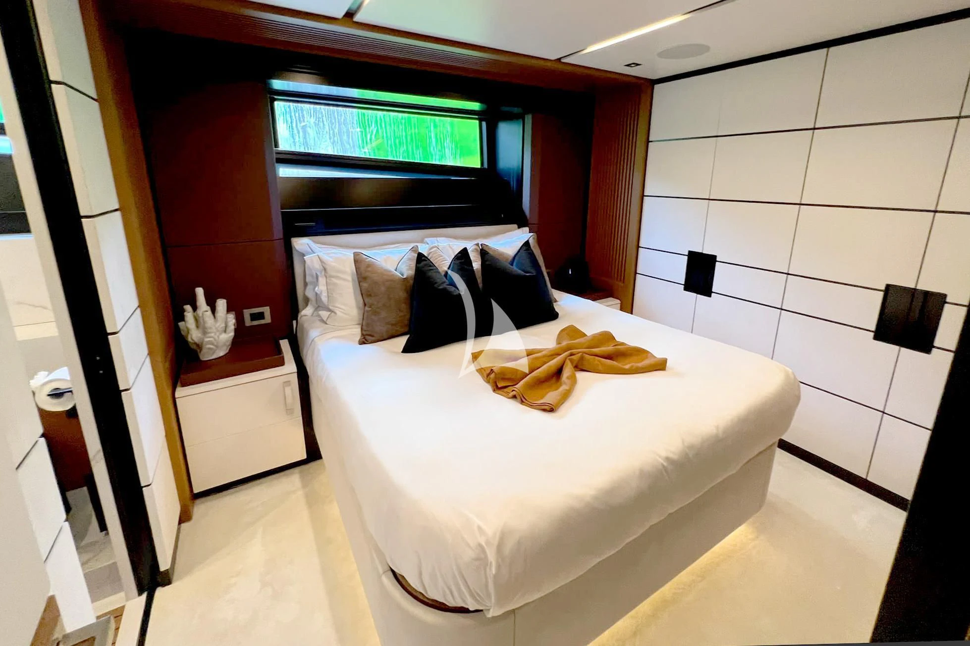 a bedroom with a bed and a mirror aboard BAD MUTHA Yacht for Sale