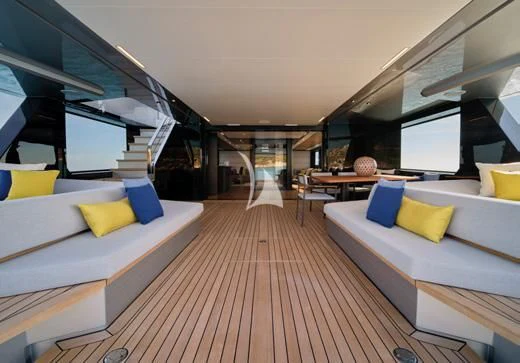 a room with a wood floor and white couches aboard BAD MUTHA Yacht for Sale