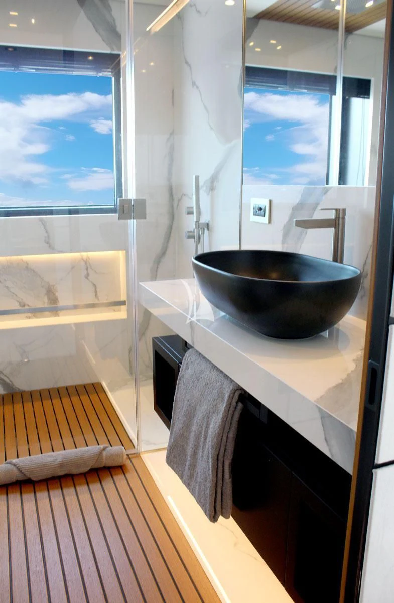 a bathroom with a sink and a bathtub aboard BAD MUTHA Yacht for Sale
