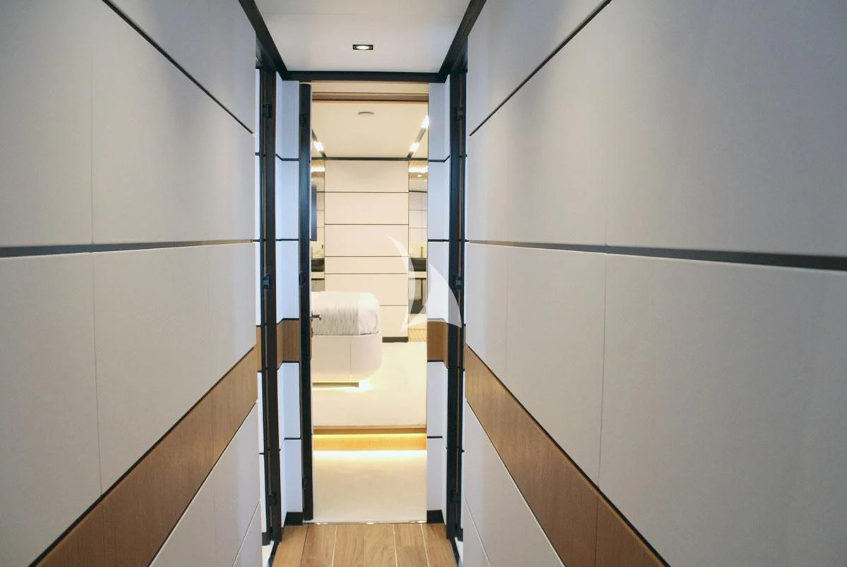 a hallway with a white wall aboard BAD MUTHA Yacht for Sale