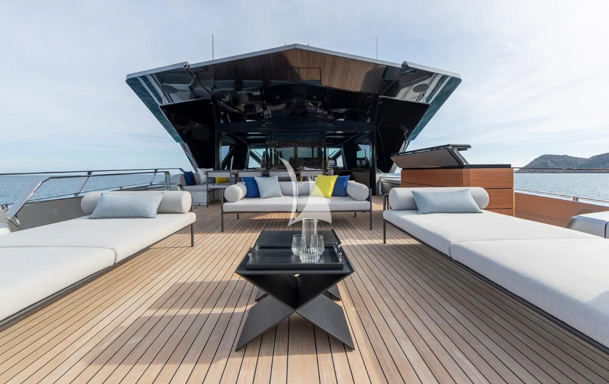 a deck with a table and chairs on it aboard BAD MUTHA Yacht for Sale