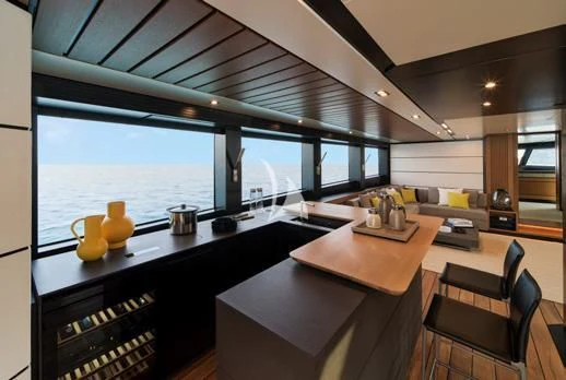 a kitchen with a large window overlooking the water aboard BAD MUTHA Yacht for Sale