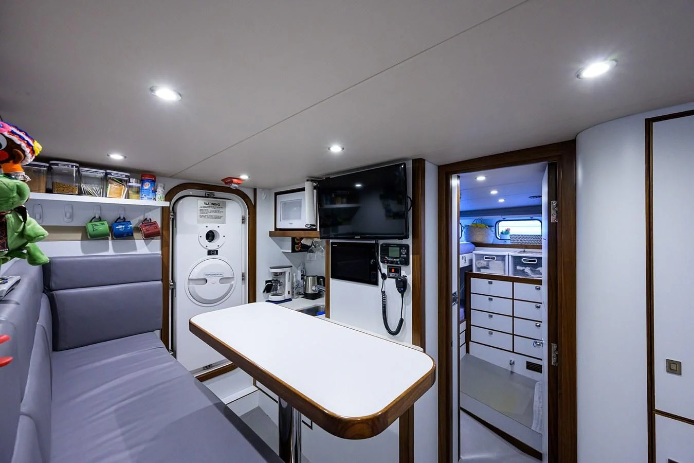 a white kitchen with a white table and microwave aboard LACEY KAY Yacht for Sale